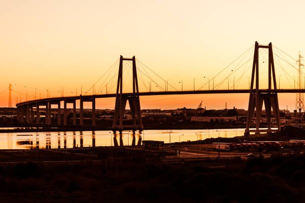 Sunset silhouette of the large suspension concrete bridge near Figueira da Foz, Portugal